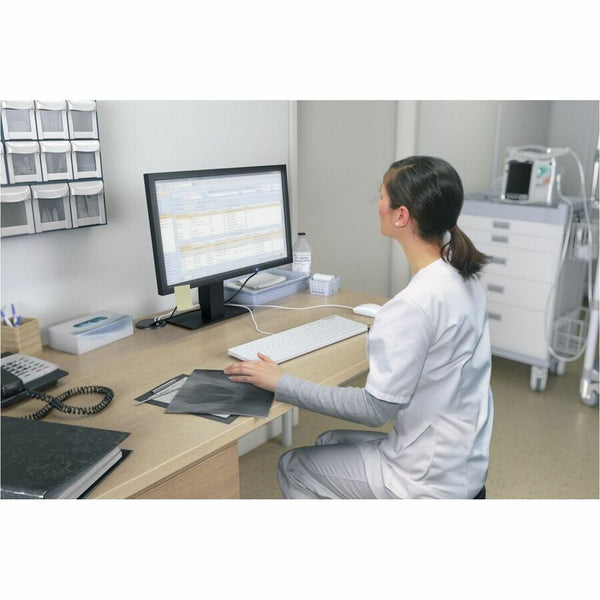 A nurse looking at a screen in a doctor's office