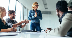 Project manager talking to team in an office.