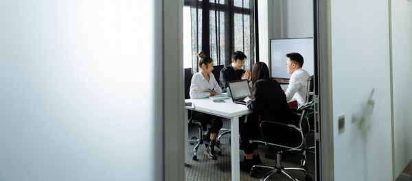 Group of people working together in a modern office setting.