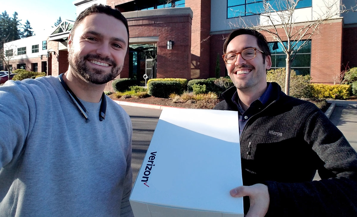 Lance Sheidenberger and Andy Nelson from LTT Partners holding a Verizon box.