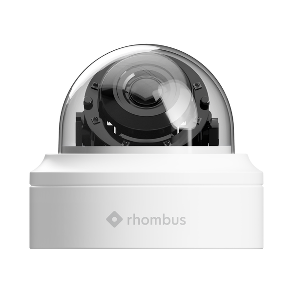 White security camera with clear dome on a white background, featuring the Rhombus logo.